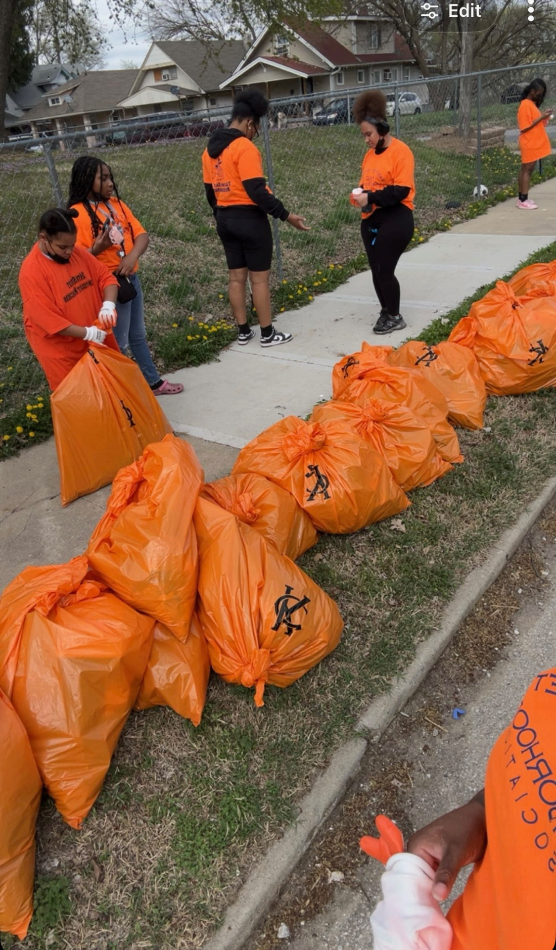 Volunteers collecting bags during a 3rd District neighborhood cleanup.